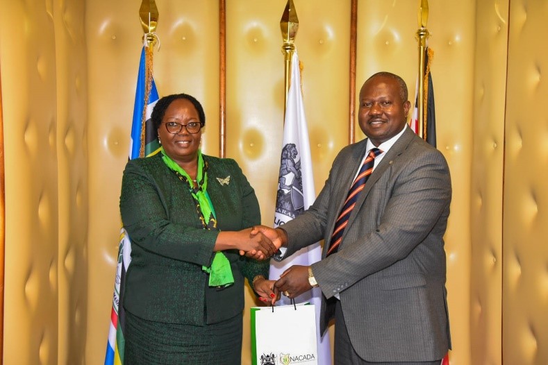 The Principal Administrative Secretary for The ministry of Interior and National Administration Ann Ng'etich who chaired the meeting receives a gift hamper from her host, NACADA CEO Dr. Anthony Omerikwa, MBS  